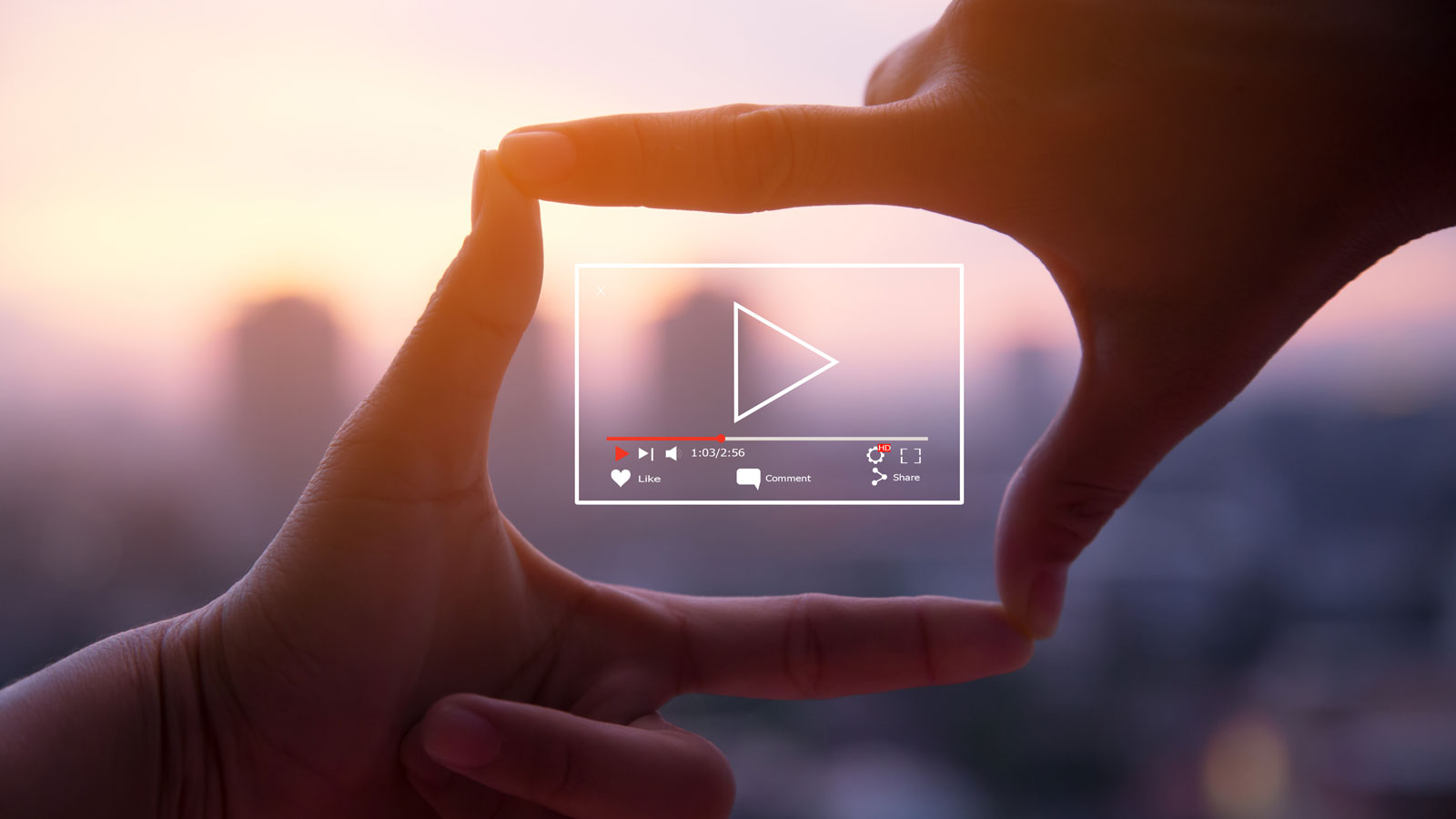 hands forming square around video play icon hands forming square around video play icon