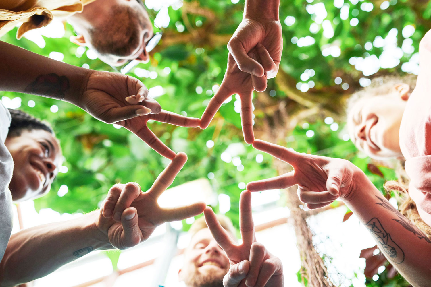 group of hands forming a star