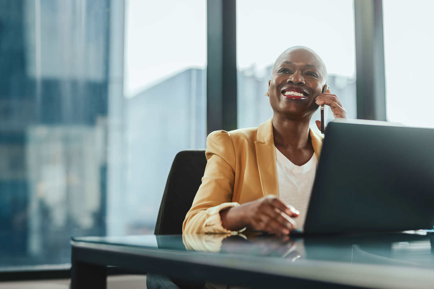 professional woman at desk with laptop in corporate office