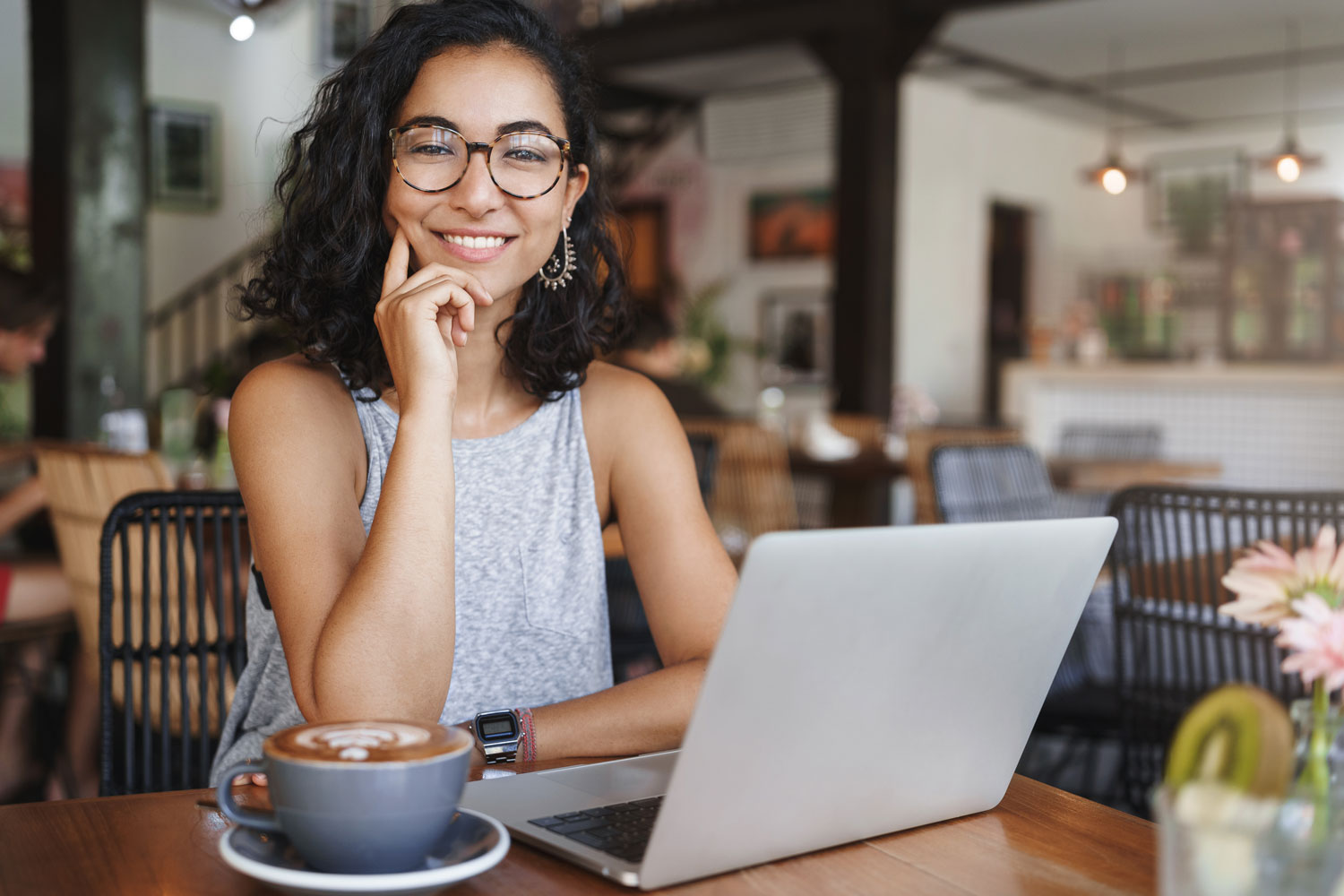 young woman with laptop in coffee shop