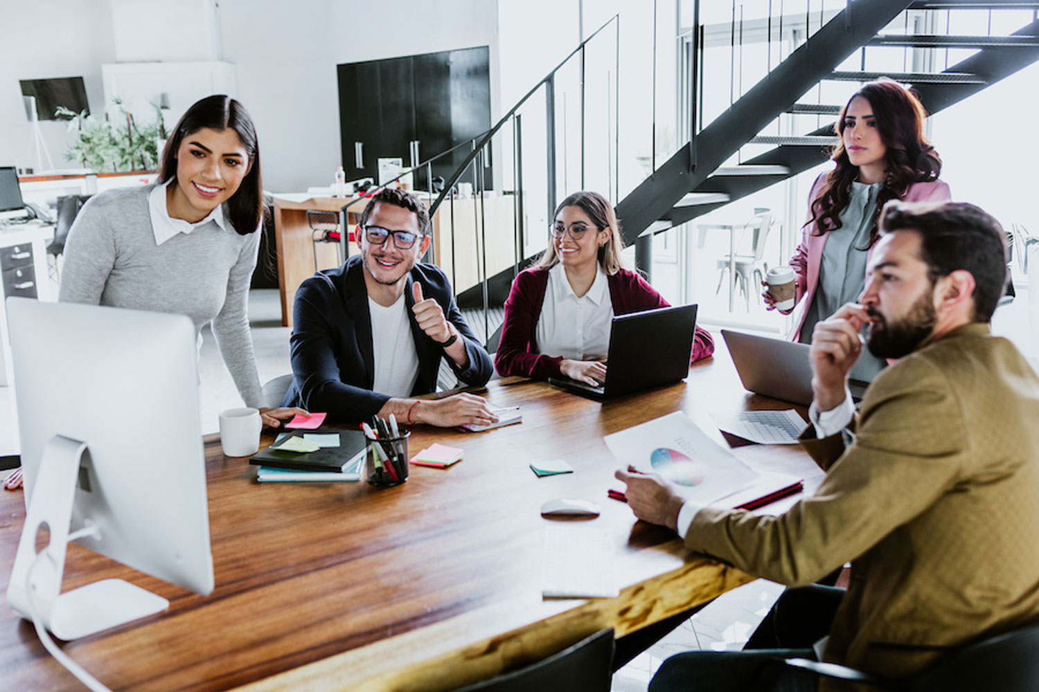 group of young professionals at conference table group of young professionals at conference table