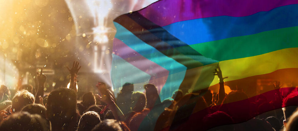 crowd of people with rainbow flag