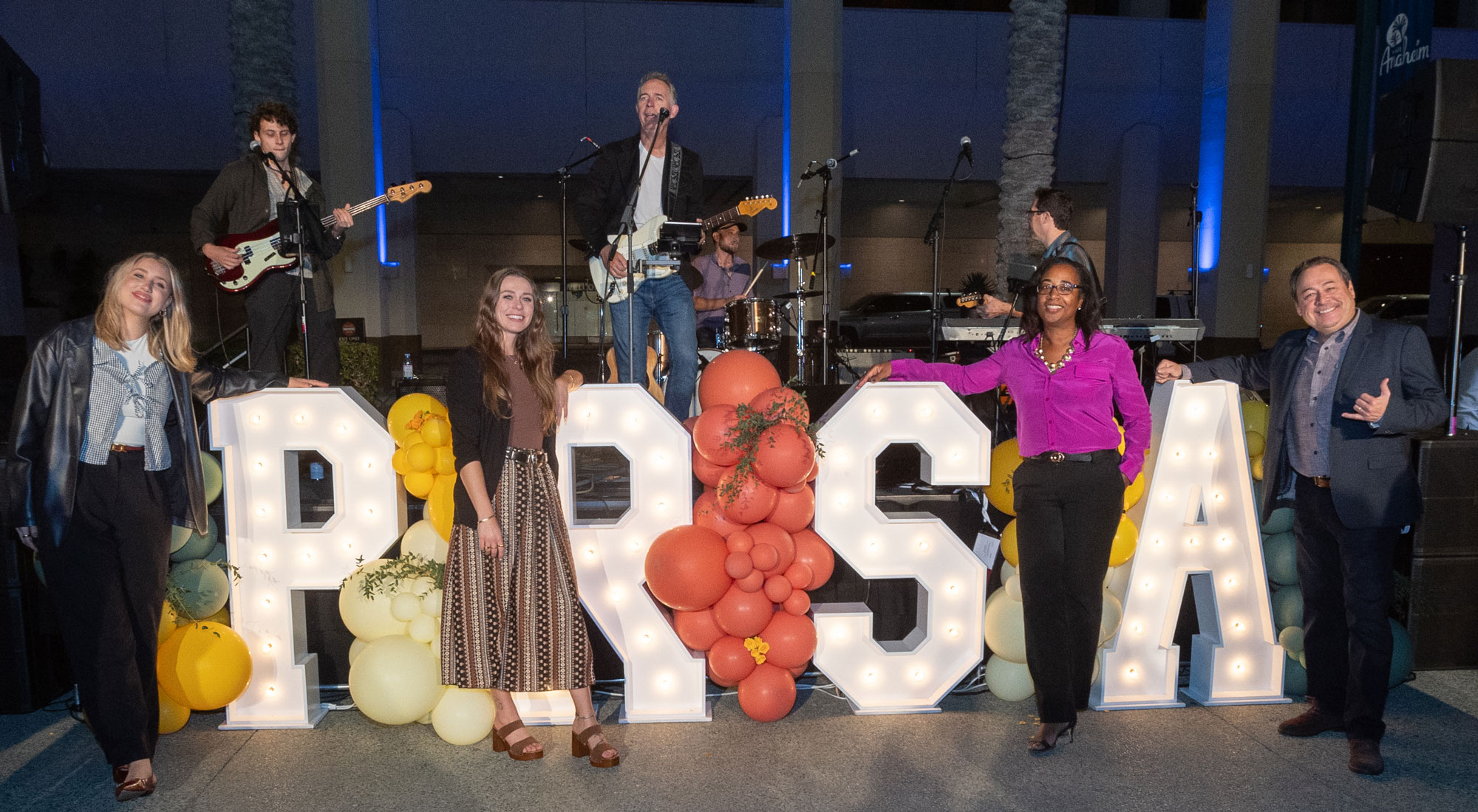 PRSA initials in lights with balloons