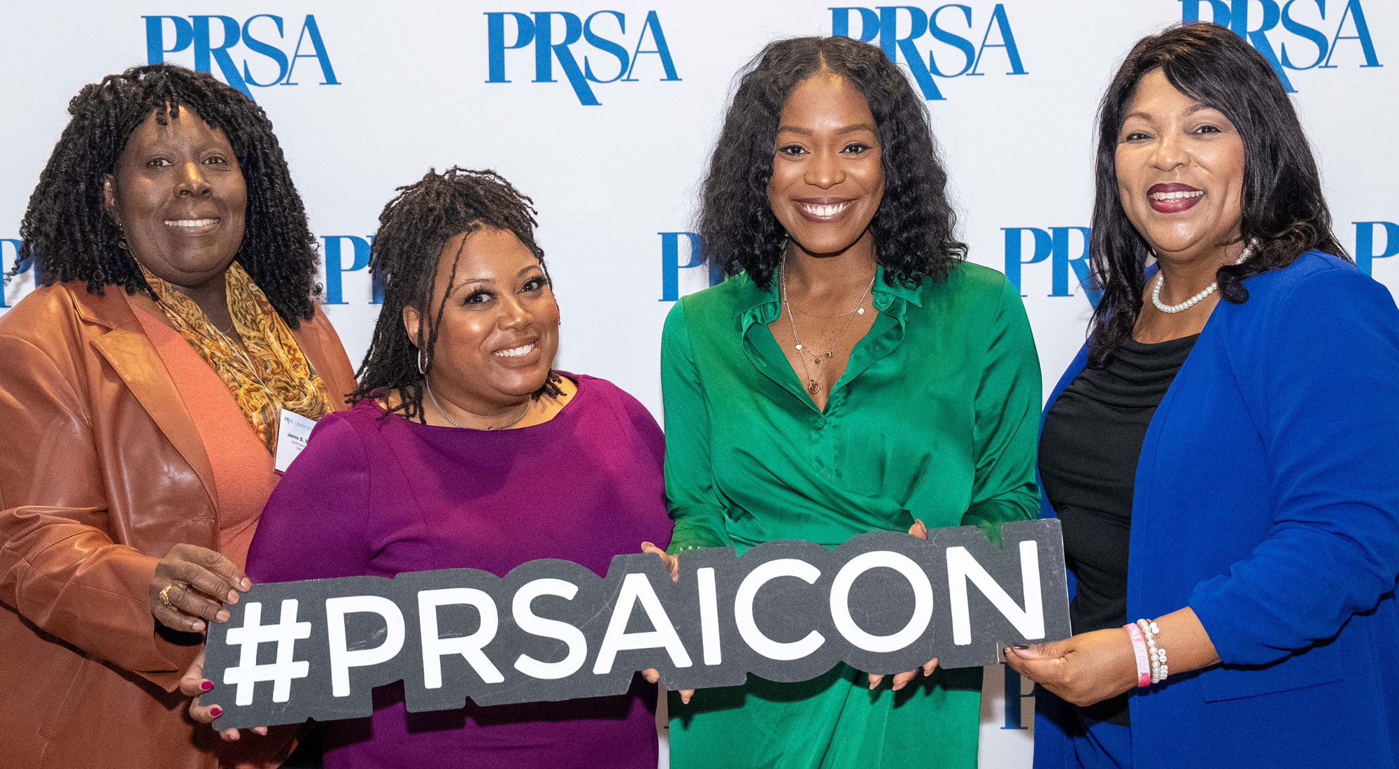 PRSA ICON attendees holding hashtag sign