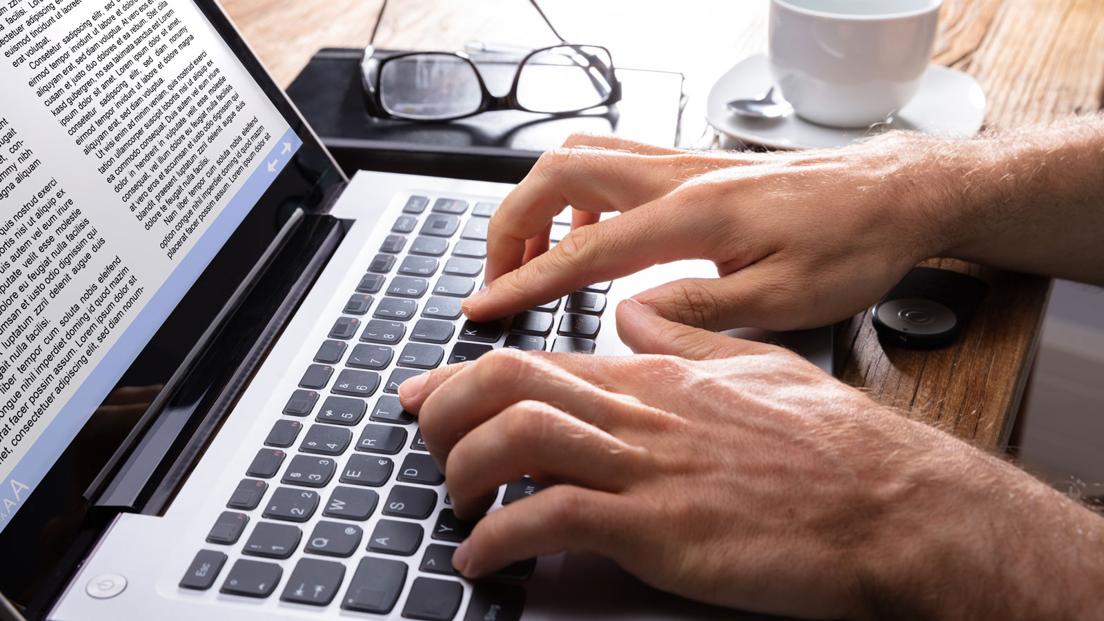 fingers typing on laptop