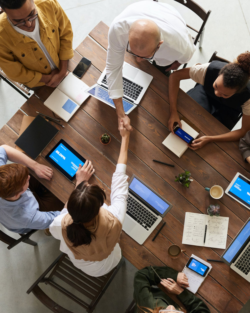 handshake across a conference table handshake across a conference table