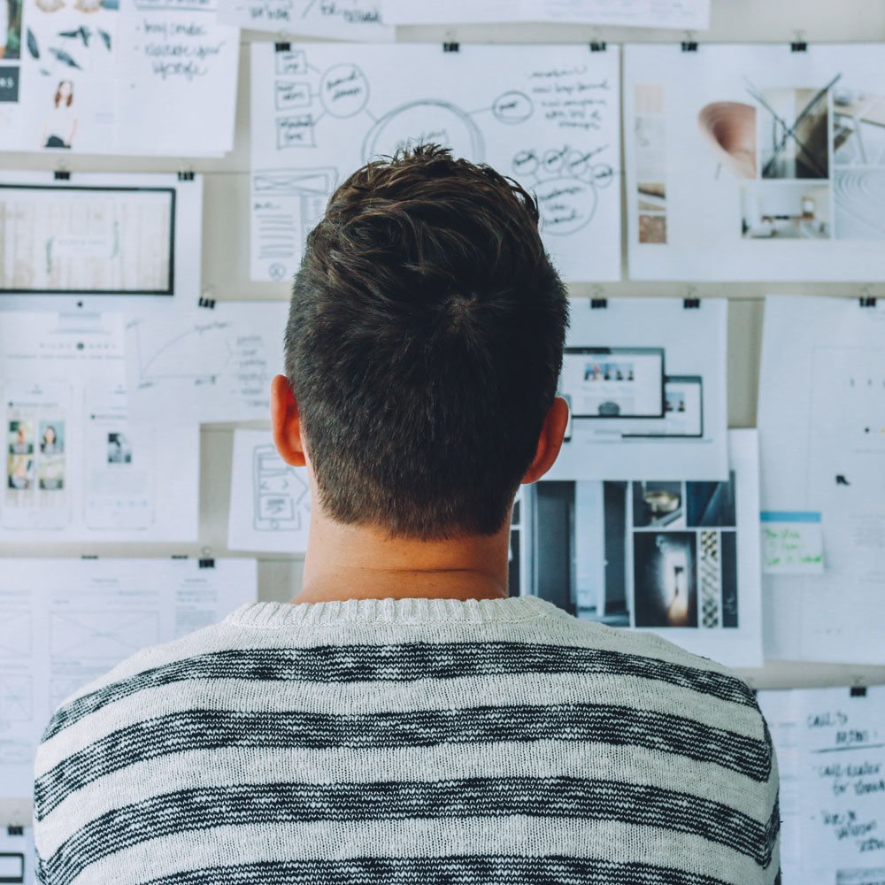 man facing whiteboard with complex writing man facing whiteboard with complex writing