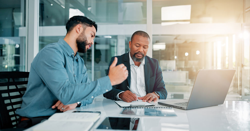 two men at conference table