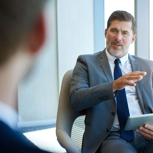 seated man talking and gesturing