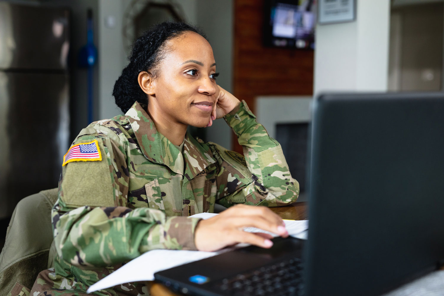young woman in military uniform using computer young woman in military uniform using computer