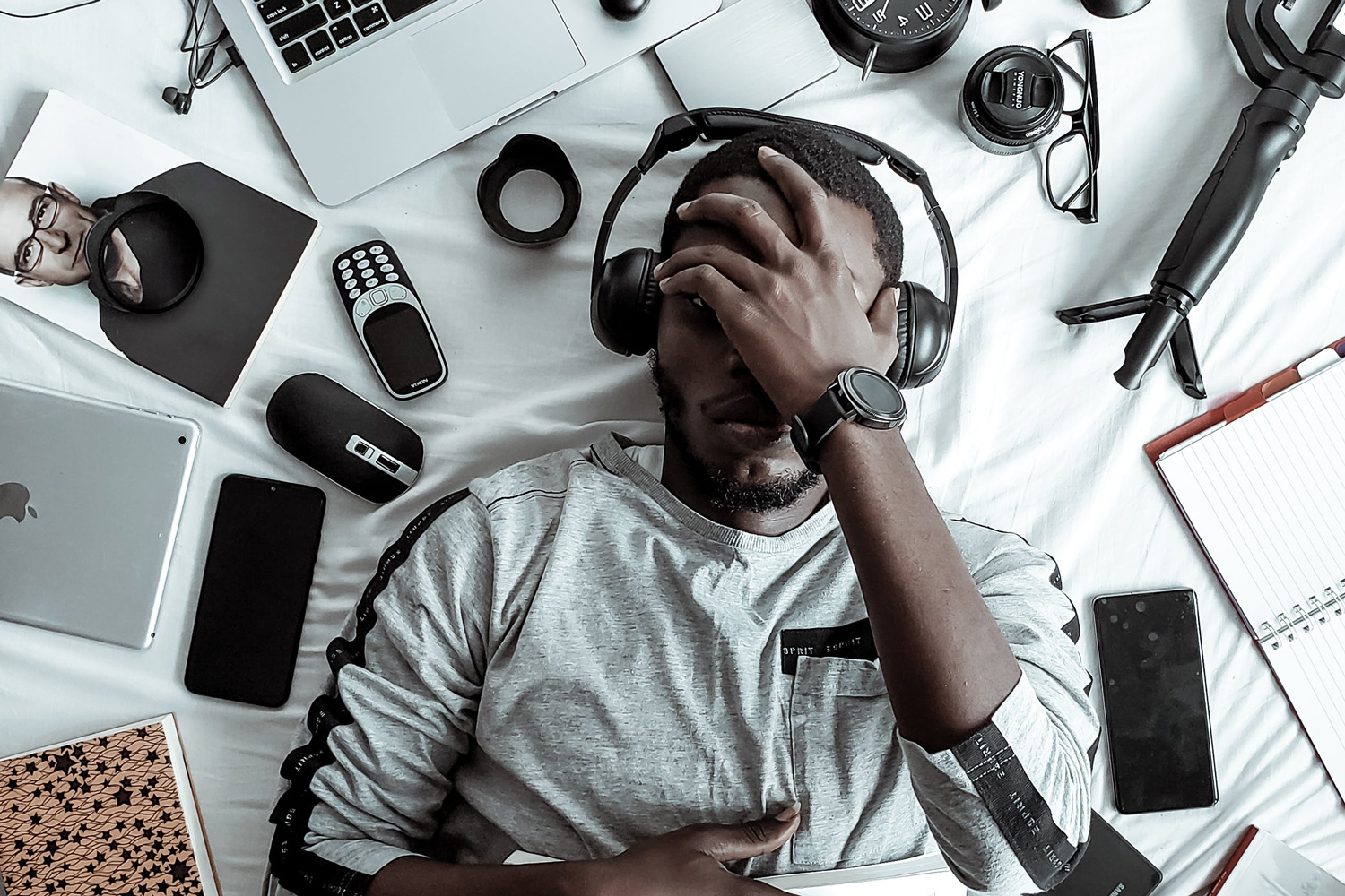 man with headphones surrounded by electronics