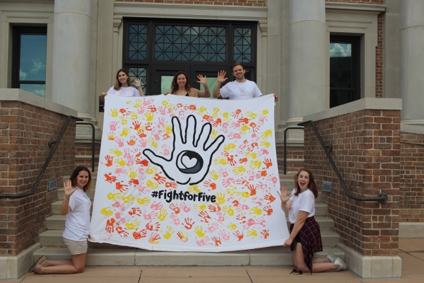 Louisiana State University Bateman Participants holding a tarp that reads 3fight for five